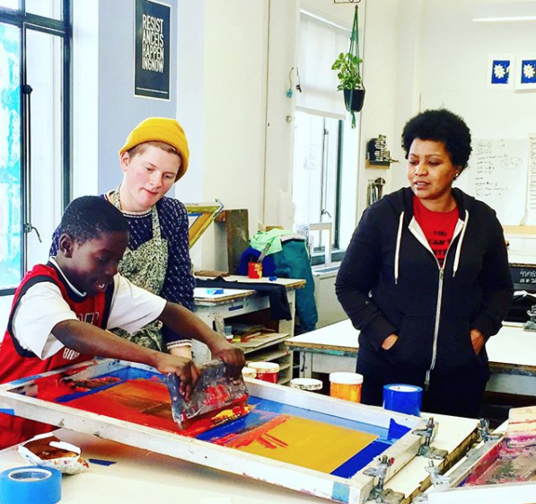 young person screen printing in print studio at Pacific Northwest College of Art PNCA