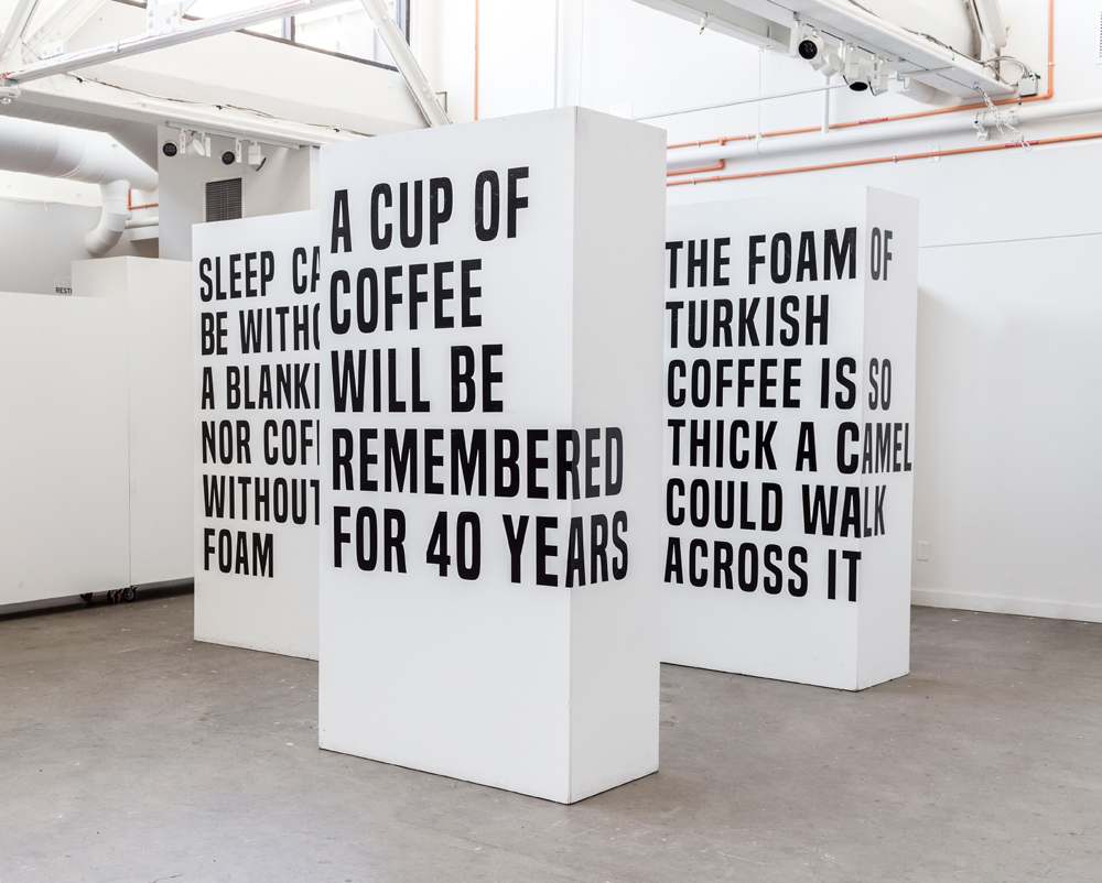 Mert Kocabagli installation featuring three blocks with words about coffee