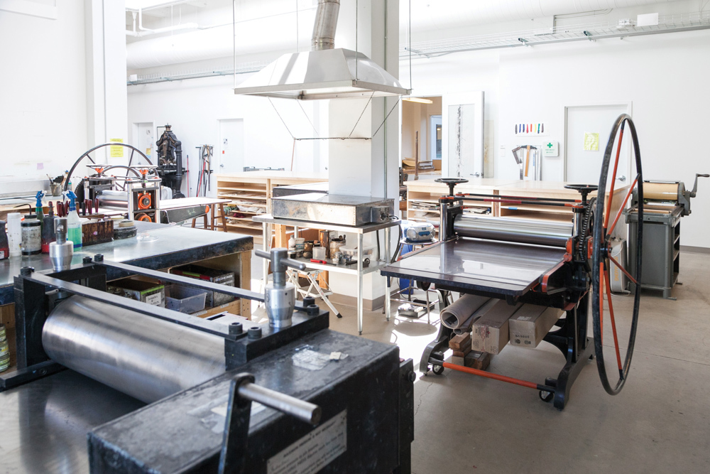 Sun-lit printing presses and other various print making equipment, part of the Print Making Lab facilities at Pacific Northwest College of Art (PNCA).