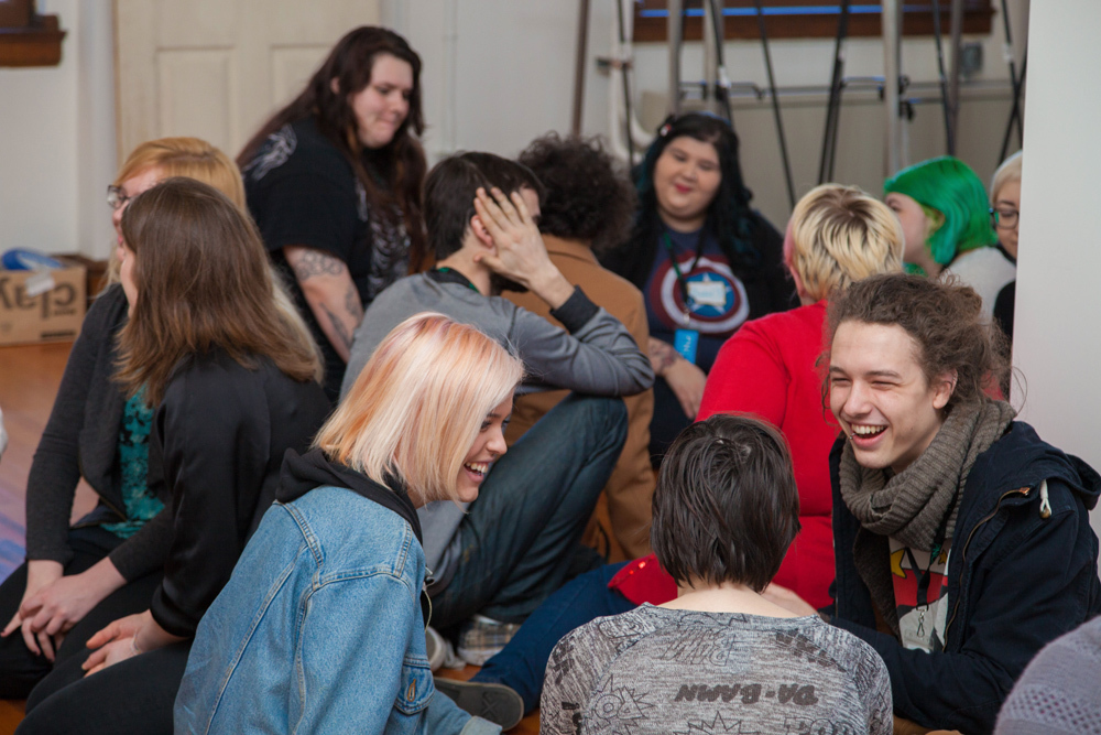 New college students sitting together laughing during the Pacific Northwest College of Art's (PNCA) student orientation day 2015.