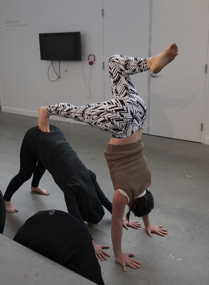 Two students practicing yoga with each other at PNCA