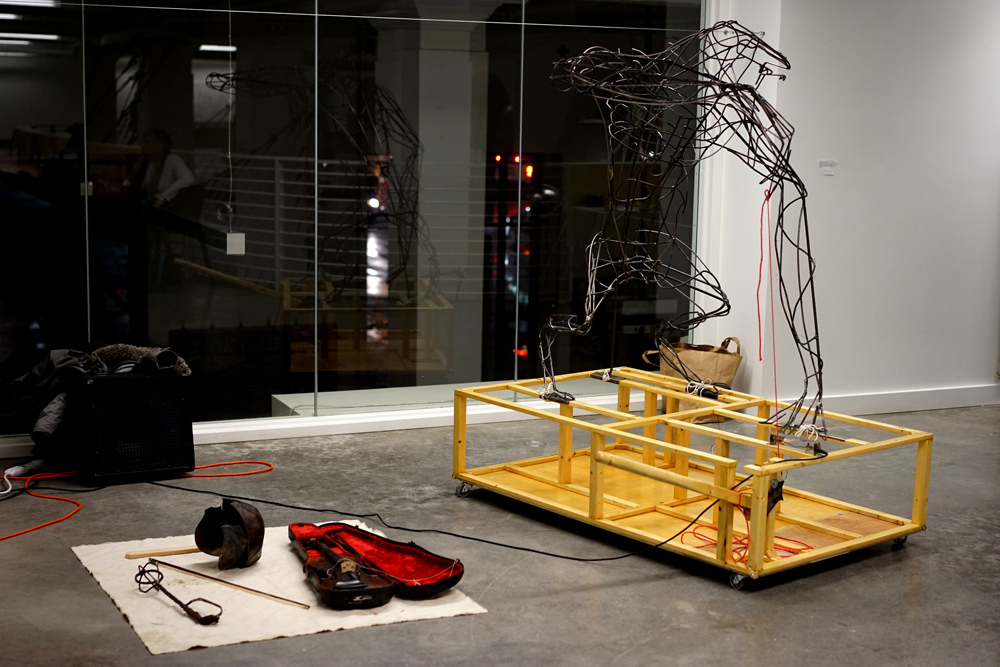 Wire sculpture and an arrangement of appropriated art objects in a student installation on the Mezzanine level of Pacific Northwest College of Art (PNCA). 